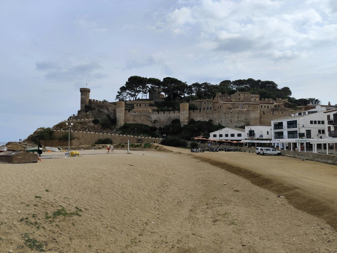 A picturesque view of Tossa de Mar's historic fortress and beach in Catalunya, Spain.