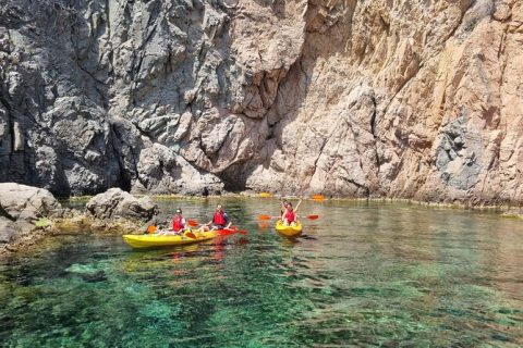 Person kayaking along the Mediterranean coast