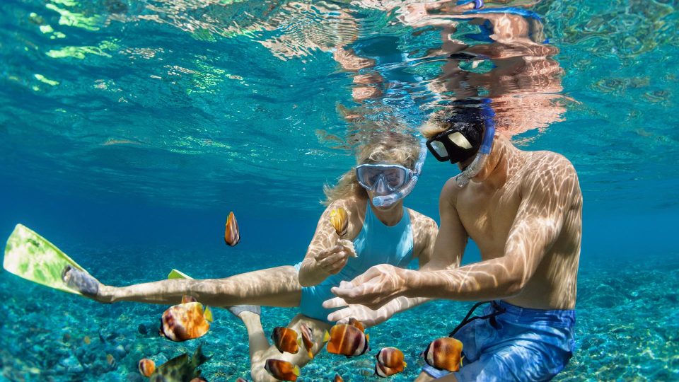 Snorkelling in a blue Mediterranean sea cave with turquoise water