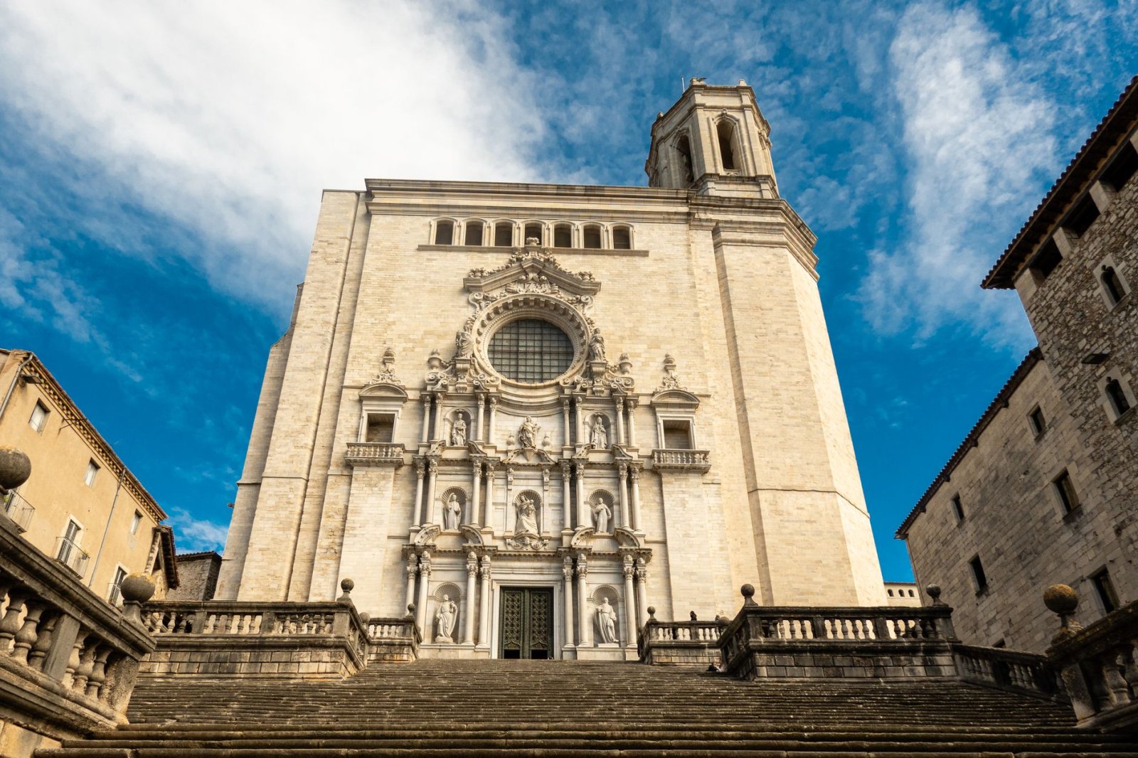 Frontal view of the iconic Girona Cathedral under a clear blue sky.